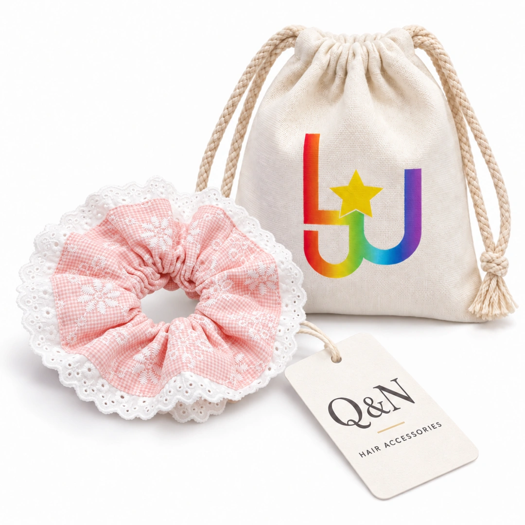 Pink lace scrunchie with a printed drawstring cloth pouch and hang tag